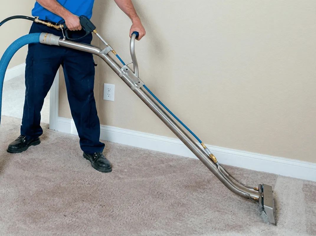 Professional operating a liquid removal machine on a carpeted floor in Tallahassee, FL